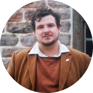 Portrait of Jake Hurner in front of brick building