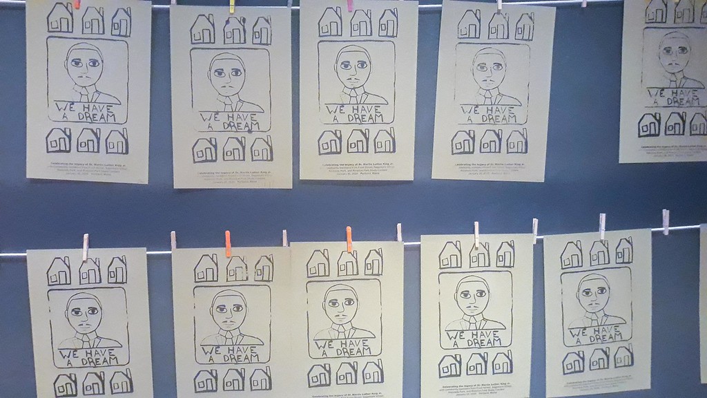 photo of screen prints hanging on a wall