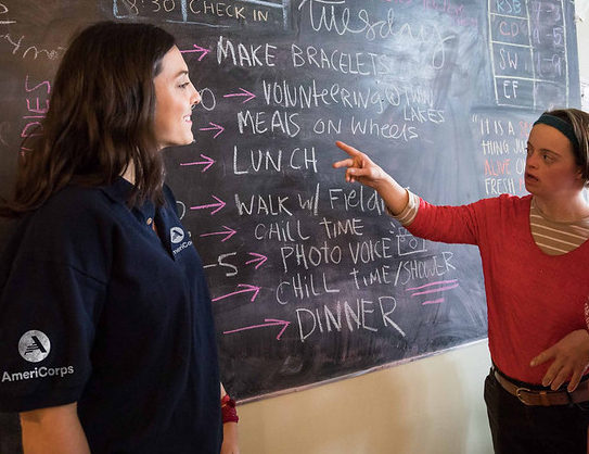 AmeriCorps member and young adult reviewing daily schedule