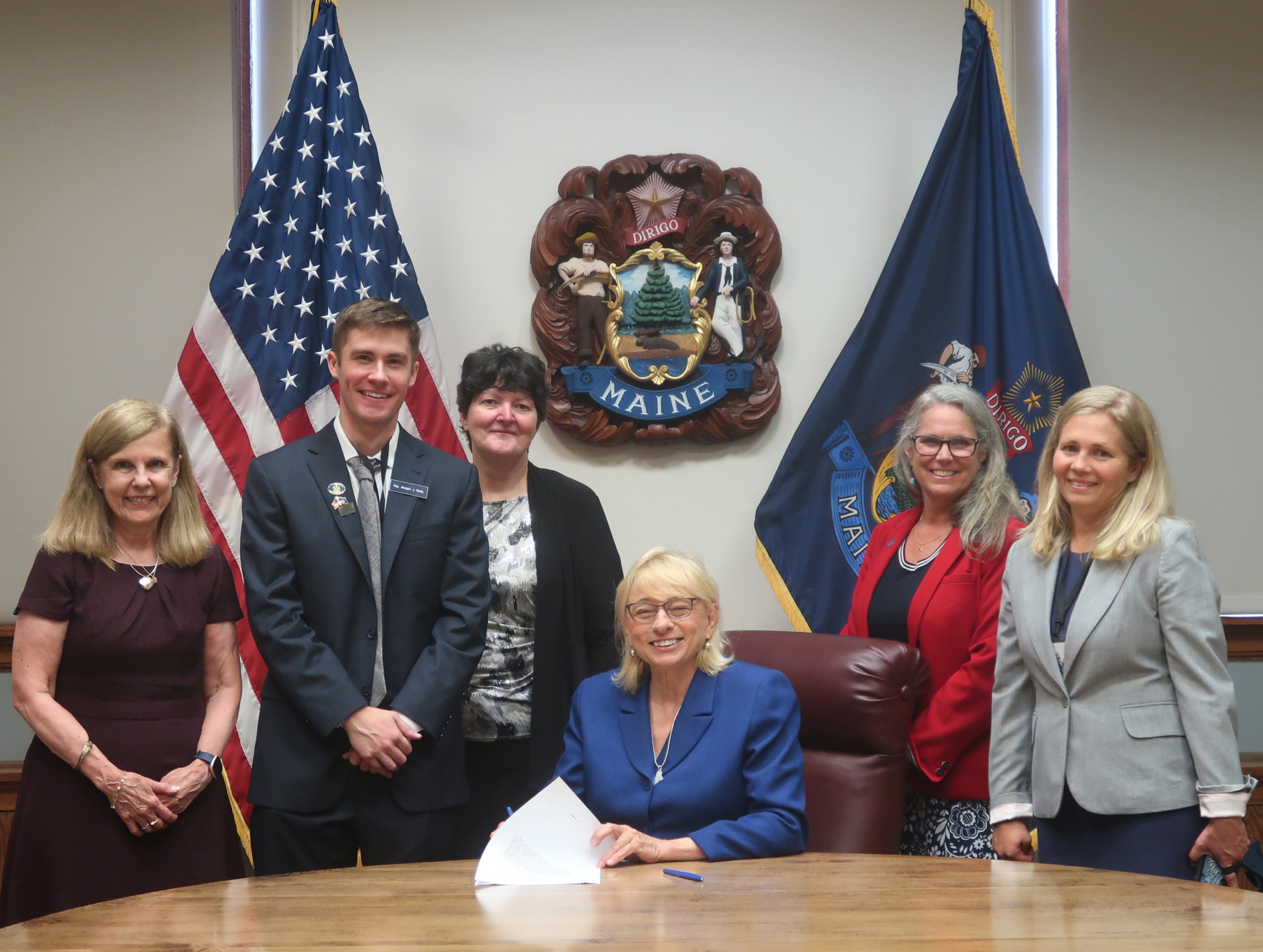 Photo of five individuals in a conference room for a ceremonial bill signing