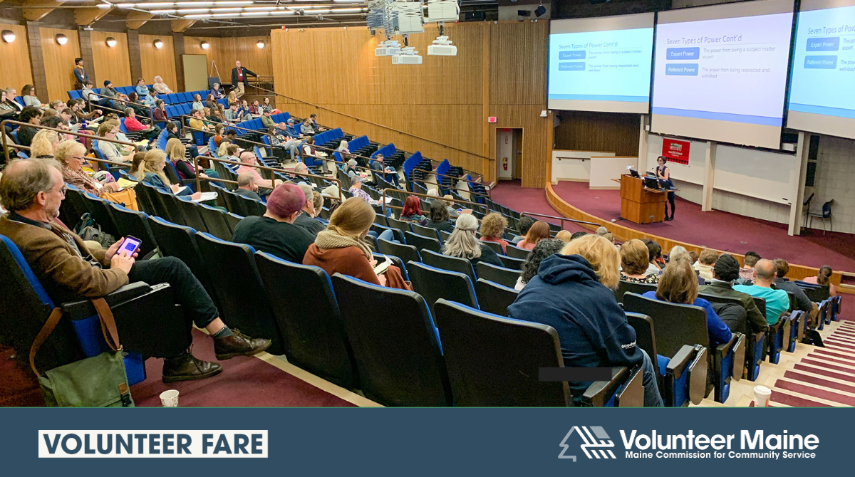 Decorative graphic featuring a photo of a full auditorium while an individual gives a presentation